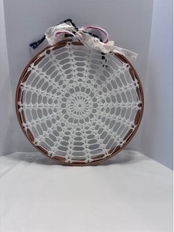 Handmade 10” crochet doily stretched inside a wooden embroidery hoop