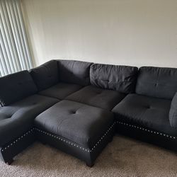 black fabric sectional couch