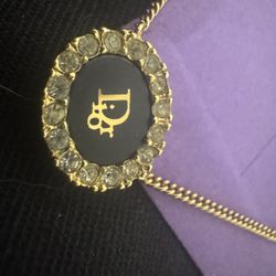 This is a gold "circle of life" pendant necklace.