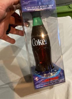 Coke bottle with car in it
