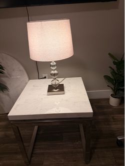 Two lamps & two ivory end tables.