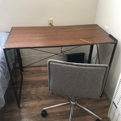 A computer desk and a rolling chair