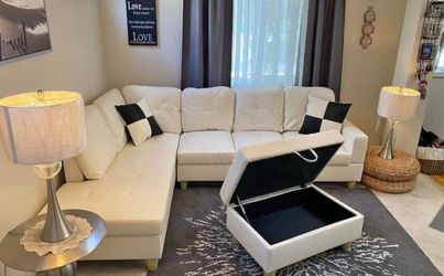 White leather sectional couch and ottoman