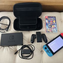 Nintendo Switch V2  bundle with Red and Blue Joy-Cons, game, and carrying case
