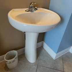 Pedestal sink with faucet
