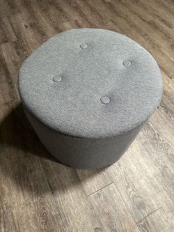 Round storage ottoman with in grey
