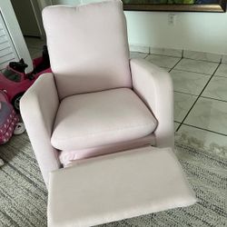 Soft pink upholstered recliner chair by Baby GAP x Delta Children.