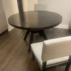 A Dining Table With Two Chairs 