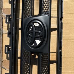 New Black Toyota Grill Insert and a Used Chrome Toyota Grill 