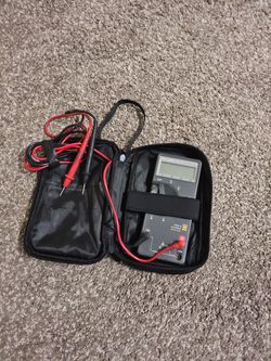 Fluke 73 Series III handheld digital multimeter with test leads in a carrying case.