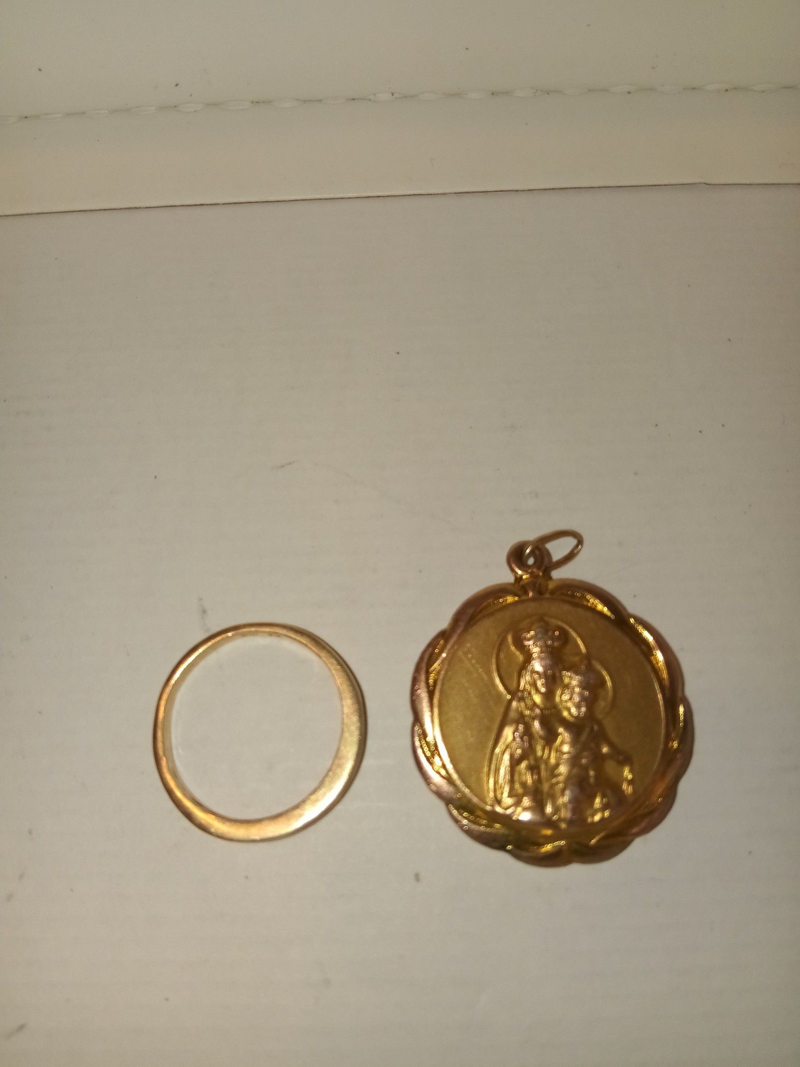 10 karat gold ring with diamonds and a gold pendant
