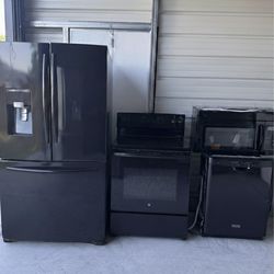 Black kitchen appliances with large refrigerator