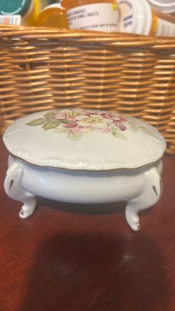 This antique porcelain trinket footed box.