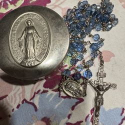 vintage blue bead rosary with a Miraculous Medal centerpiece and a crucifix, often found in a matching case.
