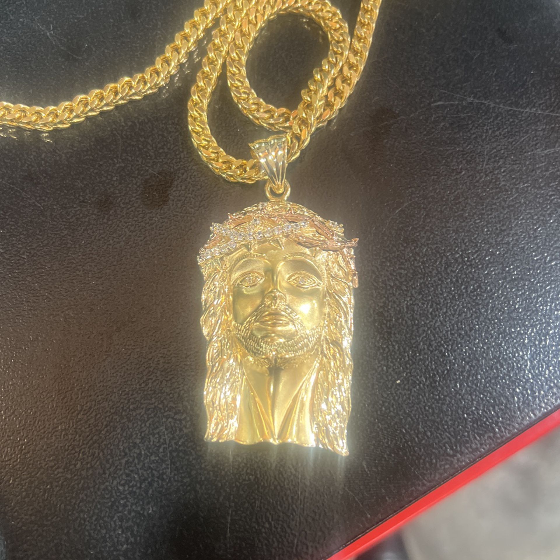 14 karat gold chain with Christ pendant where is approximately 77 g
