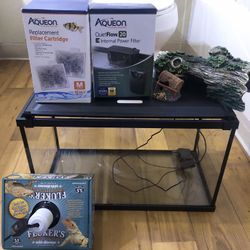 Fish Tank, Power Filter, Deluxe Clamp Lamp, Filter Cartridge 12 Pack and some Items for The Inside Of The Tank. 