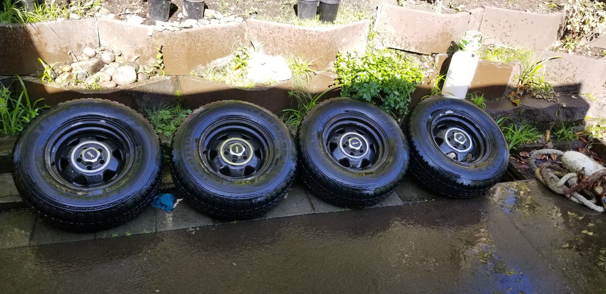 Set of 4 235/75r15 tires on jeep rims will trade for parts tools etc.