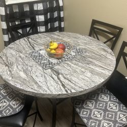 Marble Table with black chairs 