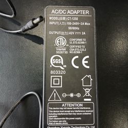 AC/DC Adapter. CT-1250. Output 42V 2.0A. Input 100-240V, 50/60Hz.