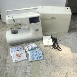 Janome memory craft 9000 electric sewing machine with five cards. Needs a good cleaning runs well could use a tuneup.