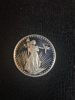 1 oz SilverTowne Saint-Gaudens silver round.