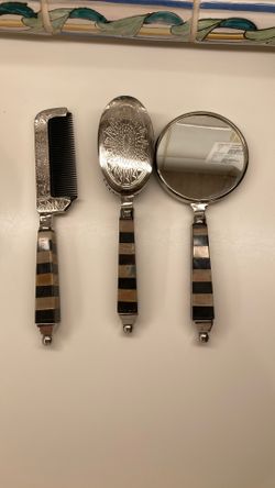 The image displays a Vintage Godinger Silver Co. Noah's Ark Design 3 Pc. Vanity Set, consisting of a comb, brush, and hand mirror.  This set features 