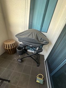 Weber Q-series electric grill with the rolling cart/stand and Weber fitted cover.
