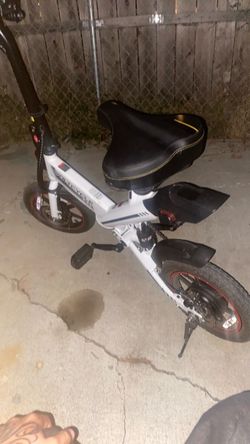 Sailnovo/Voltcycle 14-inch folding electric bicycle featuring a prominent center frame hinge and a black pedal assembly.