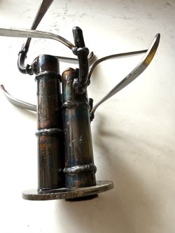 Unique Handmade Metal Bamboo Sculpture   The sculpture stands on a circular metal base and measures approximately 8 inches in width and 8 inches in he