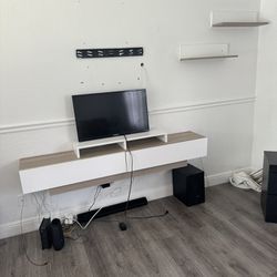 Surround sound system, with 35 inch tv with shelves and wall counter 