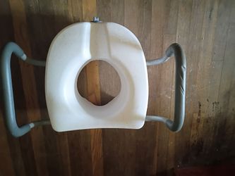 Raised toilet seat.