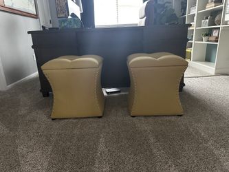 2 yellow nailhead ottomans
