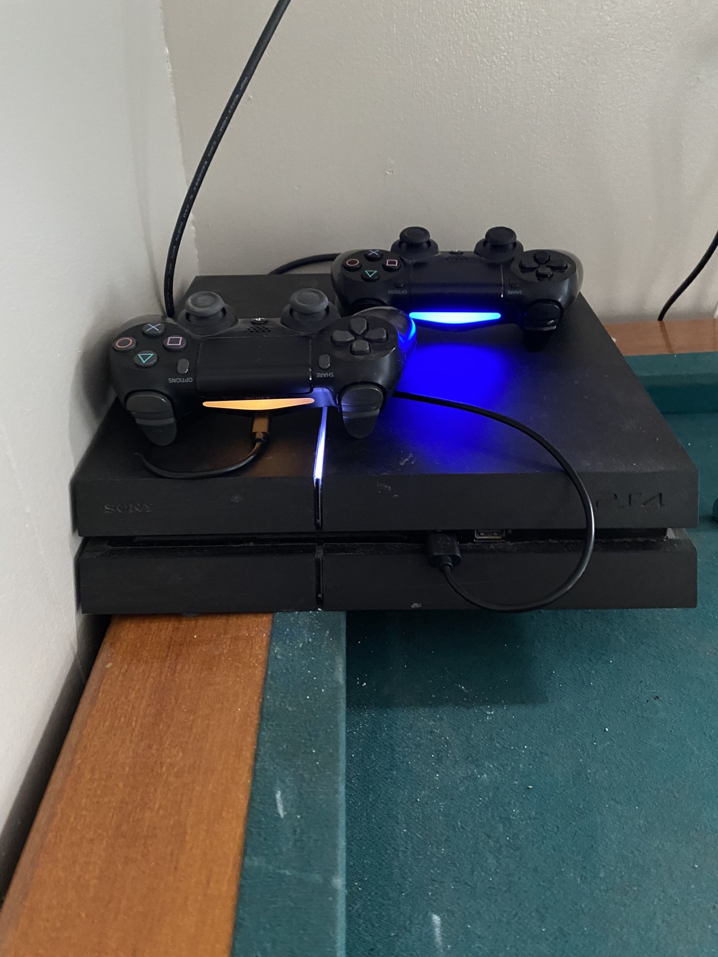 PS4 with two controllers and 9 games