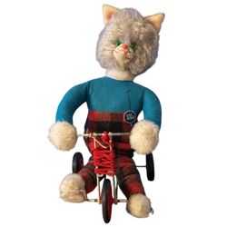 vintage MCM pull-toy featuring a plush cat on a tricycle, likely from the 1950s
