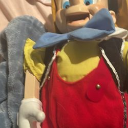 Antique Pinocchio, puppet, sings, and dances on a stream