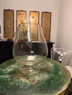 Large clear glass goblet-shaped decorative vase with a wide bowl and pedestal base.