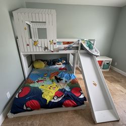 White wood frame twin over full house bunk bed with slide
