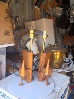 On sale a pair of hand carved wood elephant lamps .