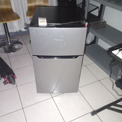 Hisense mini refrigerator with a separate freezer compartment. 