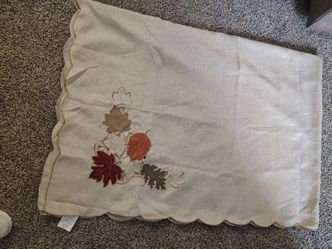 linen Thanksgiving tablecloth adorned with detailed embroidered autumn leaves and a delicate scalloped cutwork border.