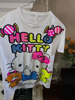 Hello Kitty graphic tee in bright neon colors. Sparkling rhinestone details on front. Large candy and character print for playful style. Lightweight, 
