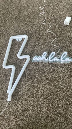 Two Neon Light Signs- One Lightning Bolt and One “Ooh La La” Sign