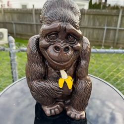 Gorilla holding banana statue