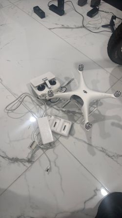 DJI Phantom 4 with remote controller, battery charger, no batteries included