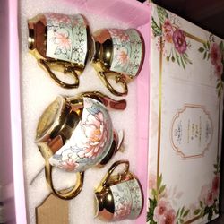 Small miniature Chinese tea set with gold detailing and baby teal accents featuring pink floral lotus designs. Includes three matching teacups and a m