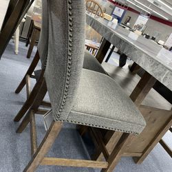 Counter height dining marble table with two chairs and storage bench