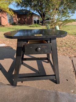 Black drop-leaf side table