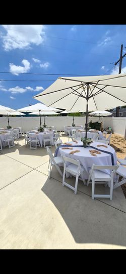 Umbrellas, round tables , resin chairs
