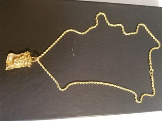 Gold plated jesus pendant on rope chain.