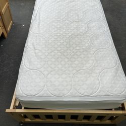 Twin bed with wooden frame
